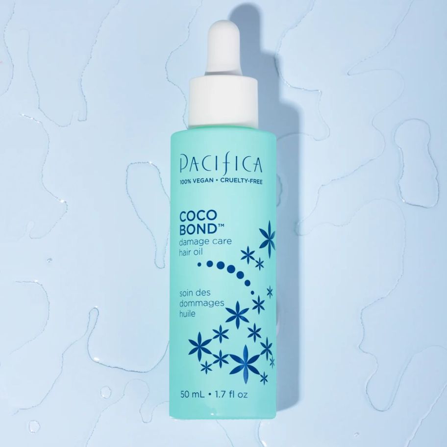 A bottle of pacifica coco bond on a blue background