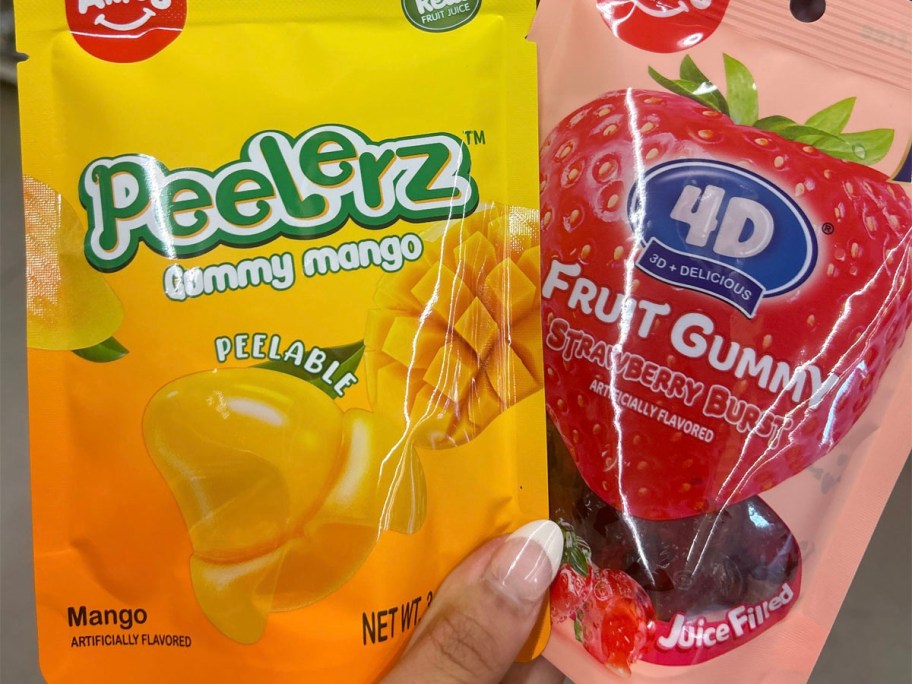 hand holding peelerz mango and strawberry candy bags