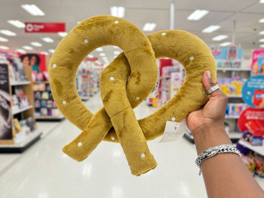 bullseye playground pretzel pillow being held by hand in store