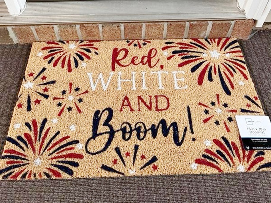 red, white and boom doormat outside of white door