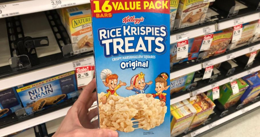 Rice Krispies Treats Crispy Marshmallow Squares, Kids Snacks, Snack Bars, Original, 12.4oz Box being held by hand in store aisle