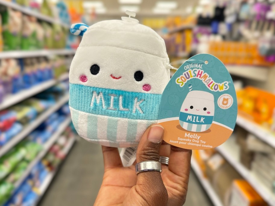 hand holding a milk carton shaped Squishmallow pet toy