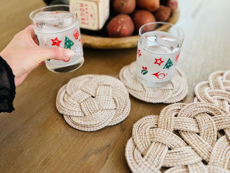 hand holding glass over trivet