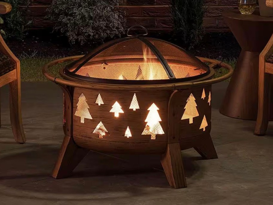 firepit with tree images on patio