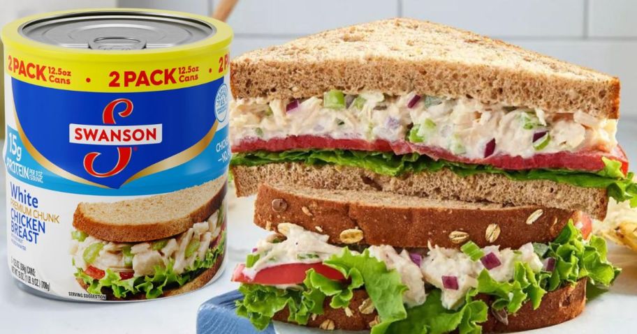 Swanson White Premium Chunk Canned Chicken Breast in Water, Fully Cooked Chicken, 12.5 OZ Can (Pack of 2) sitting next to a chicken salad sandwich on the counter