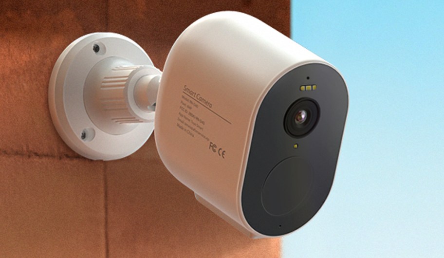 white tenvis security camera hanging on wall 