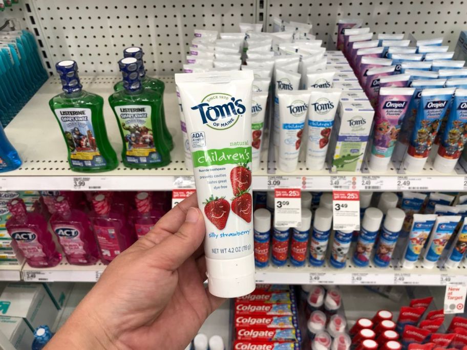 tom's children's toothpaste in hand in store