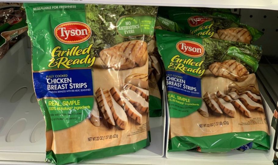 2 bags of tyson frozen chicken breast strips in a grocery store freezer display