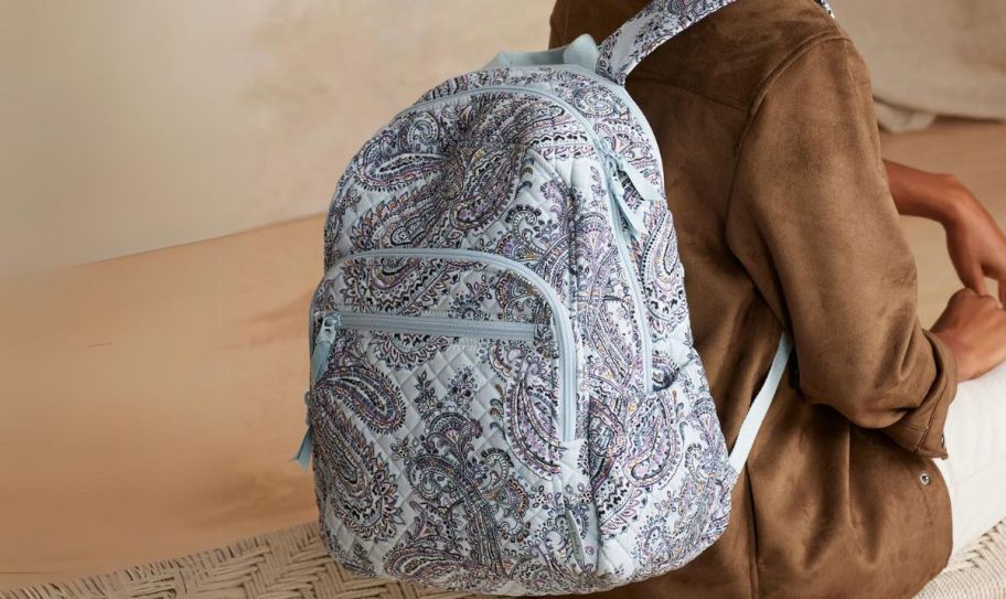 a woman wearing a vera bradley campus backpack