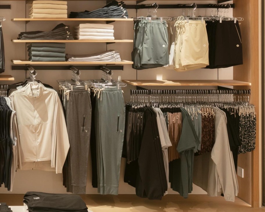 many vuori clothing items on racks in store
