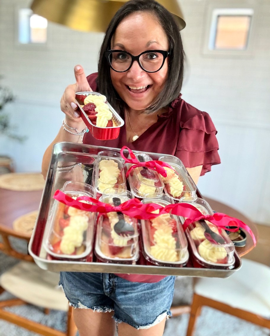 woman holding a tray of strawberry shortcake