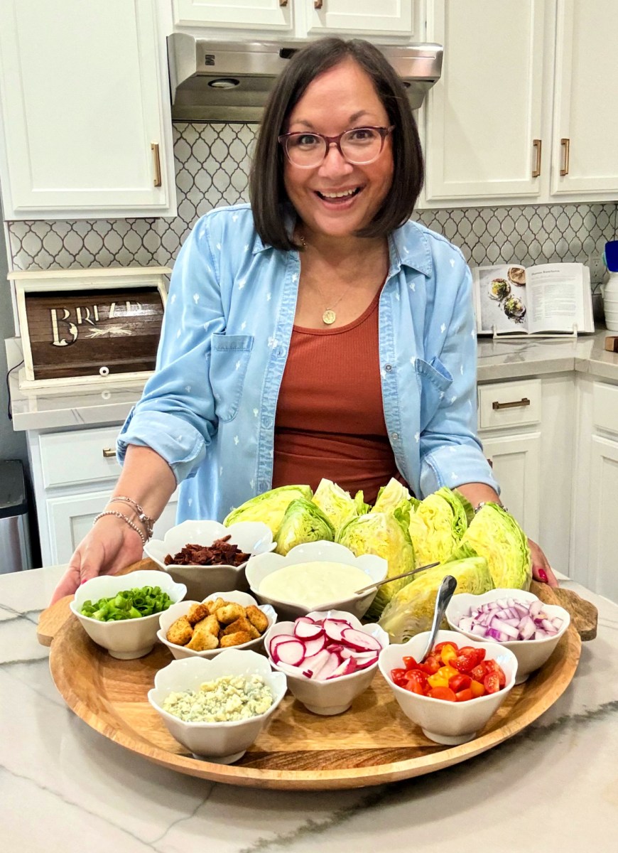 woman holding a wedge salad board