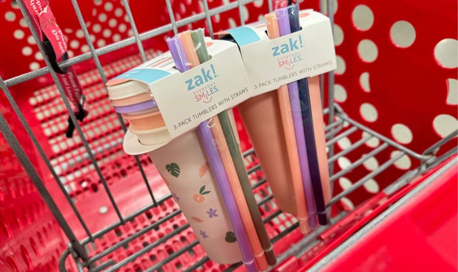 two 3 pack sets of tumblers with lids and straws in a target shopping cart