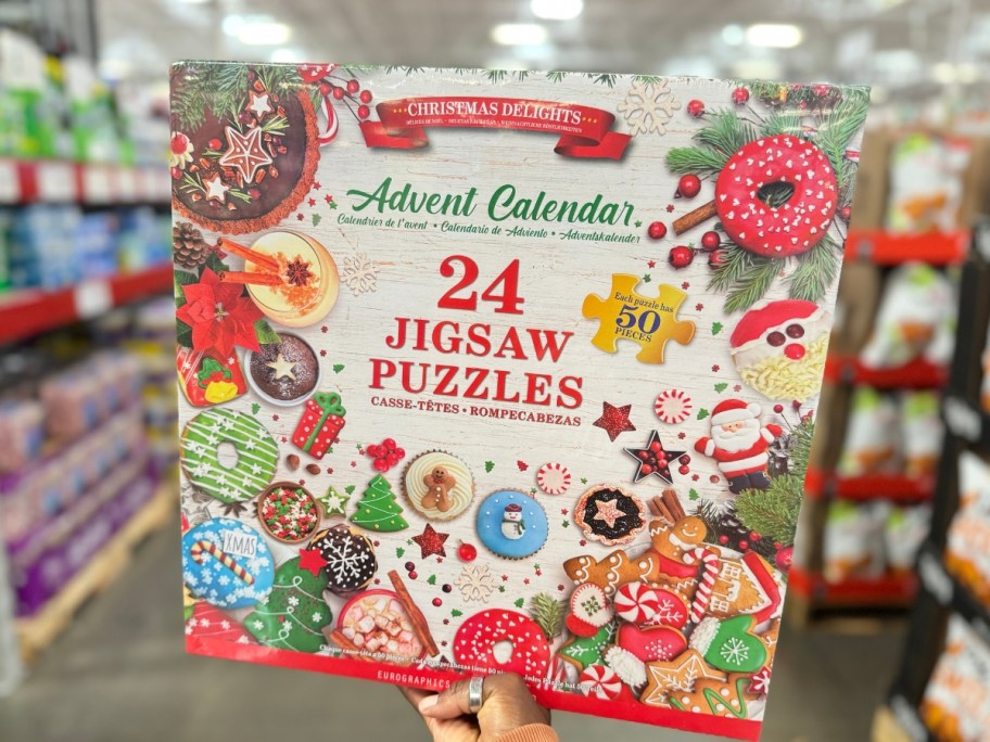 hand holding a large Advent Calendar Christmas Puzzle themed