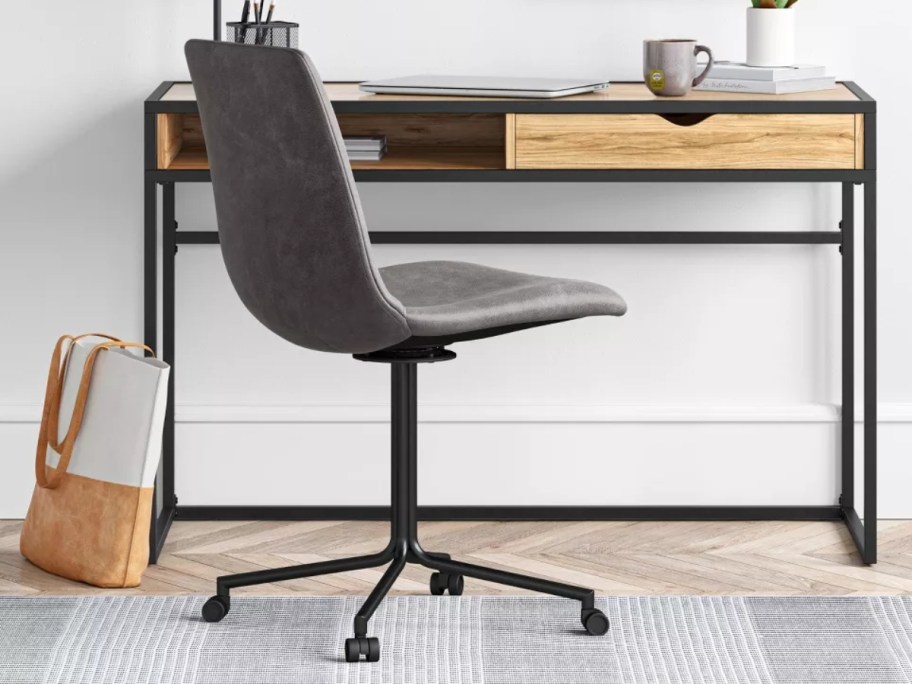 grey office chair with caster wheels by a small desk