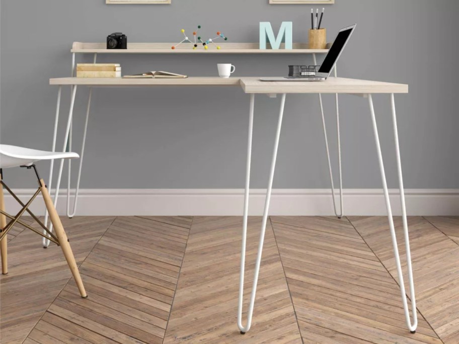 small L shaped desk with a wooden top and metal modern style metal legs