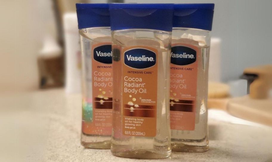 3 bottles of body oil gel on a bathroom counter