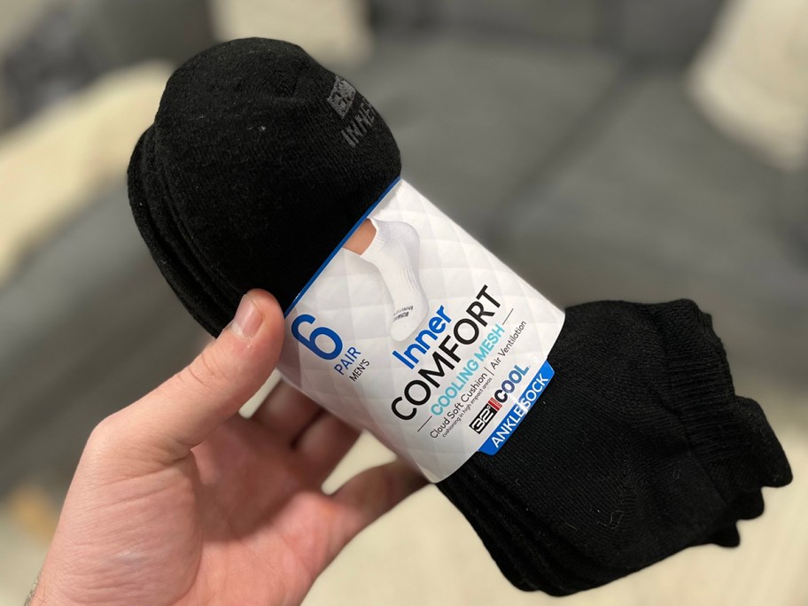 hand holding 6 pack of black 32 degrees cooling socks