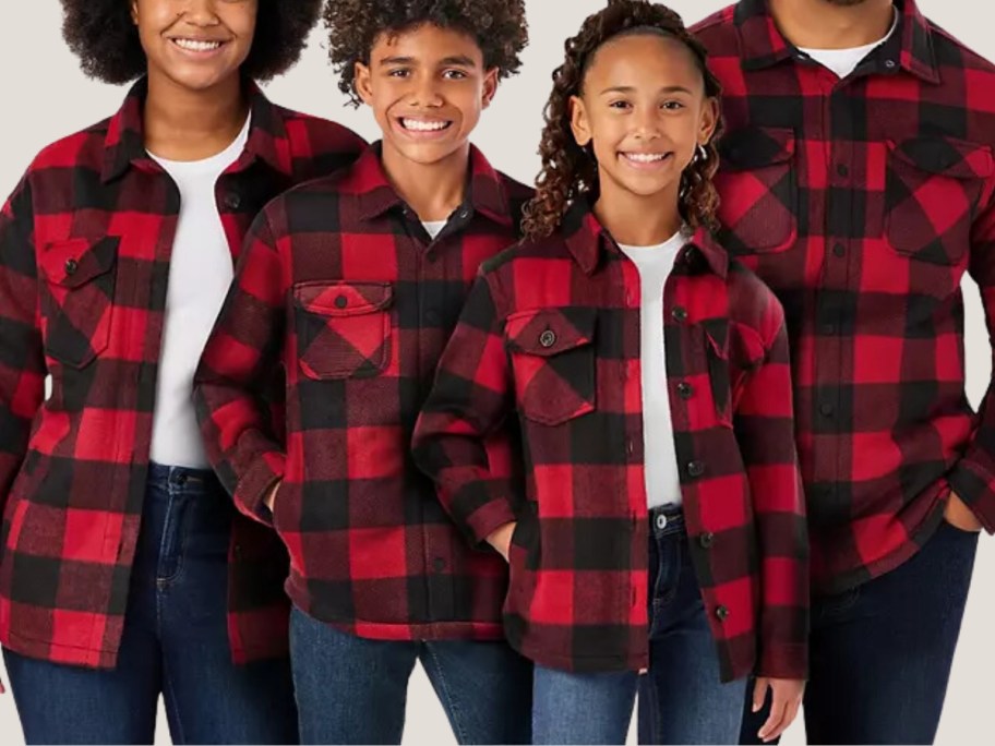 family with mom, dad, boy and girl wearing matching red and black plaid shackets