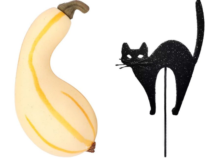 a yellow artificial gourd and a glittery black cat pick