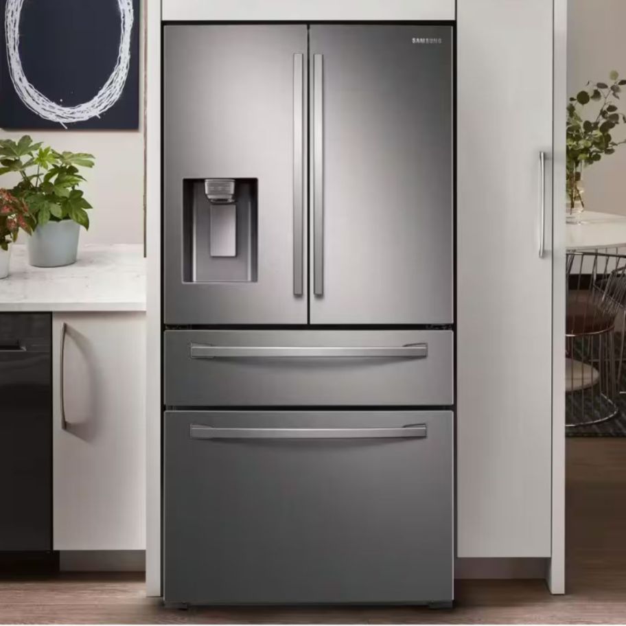 a large stainless steel fridge with double doors and drawers in a kitchen