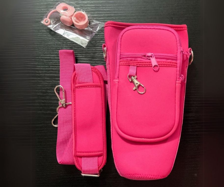 a hot pink waterbottle crossbody holder shown with accessories