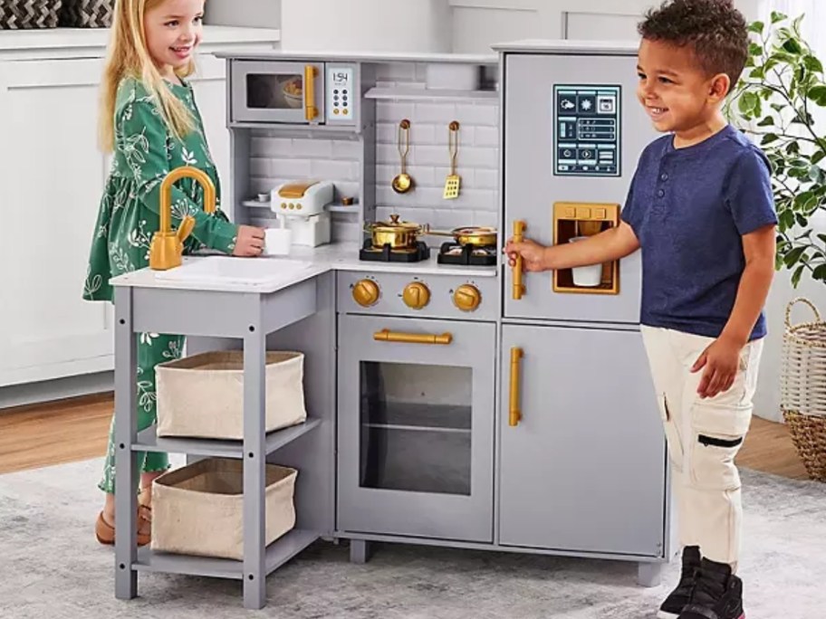 kids playing with a grey and white modern style toy kitchen playset