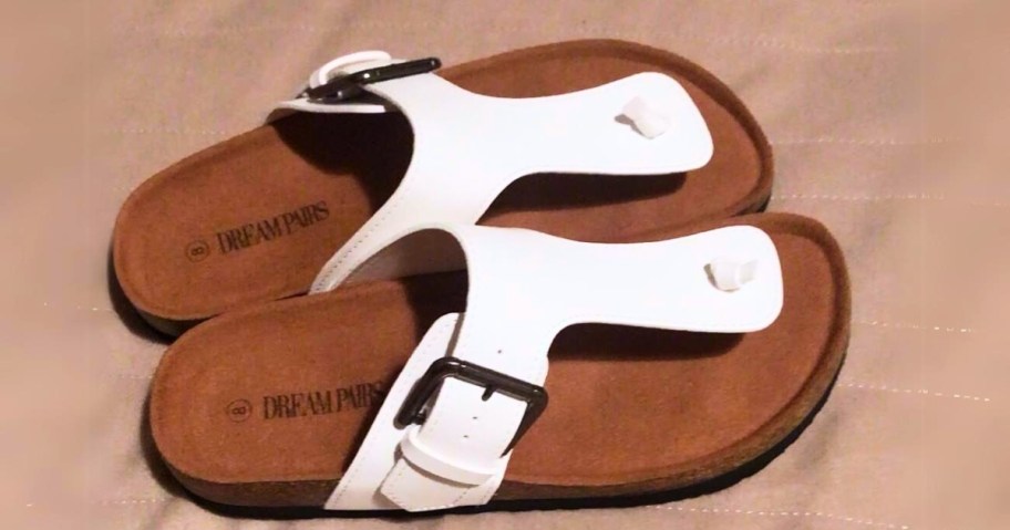 pair of womens white and brown footbed sandals