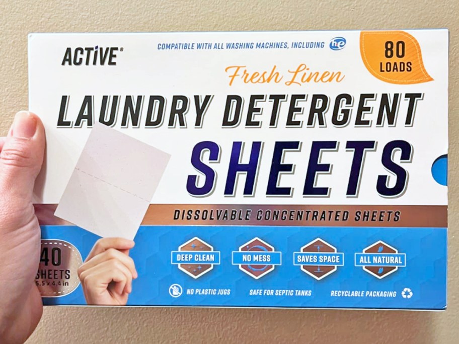 hand holding a box of Active Laundry Detergent Sheets