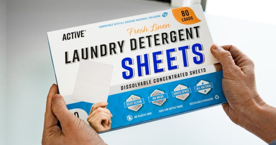 hand holding box of laundry detergent sheets