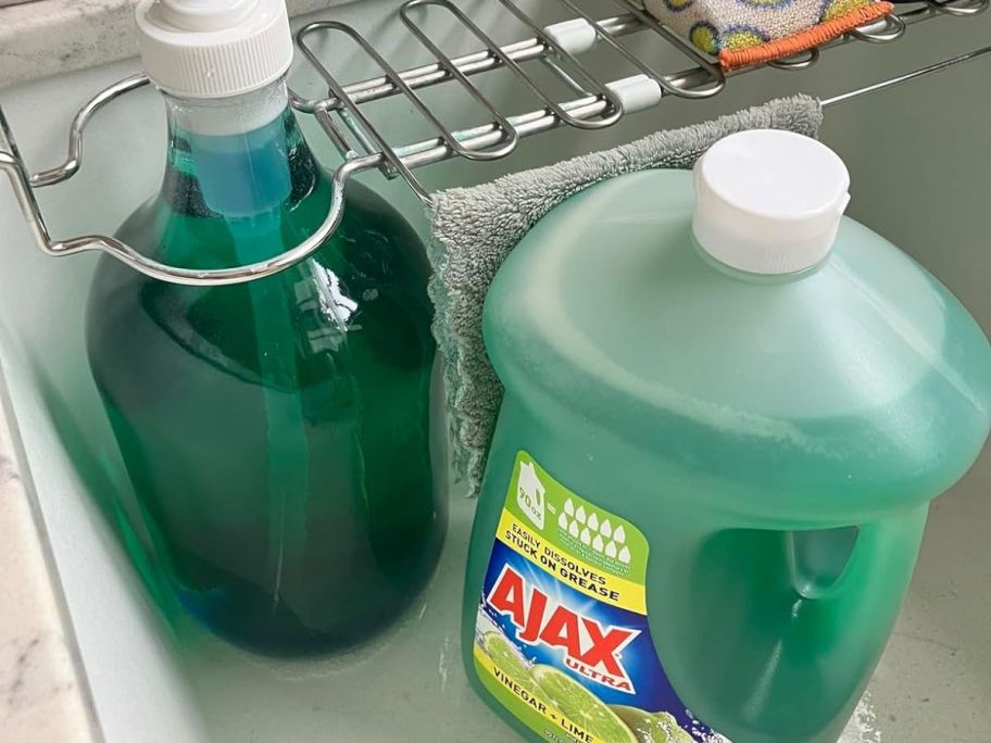 Ajax Lime & Vinegar Dish soap in a dispenser next to a huge refill bottle in a sink