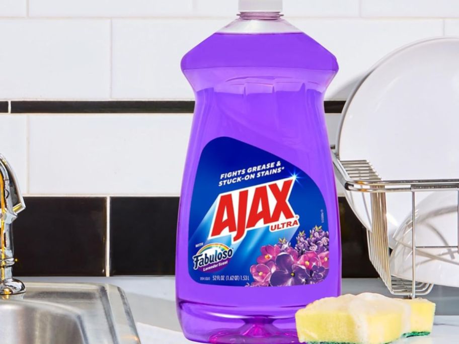 A bottle of Ajax w/ Lavender Fabuloso next to a sponge