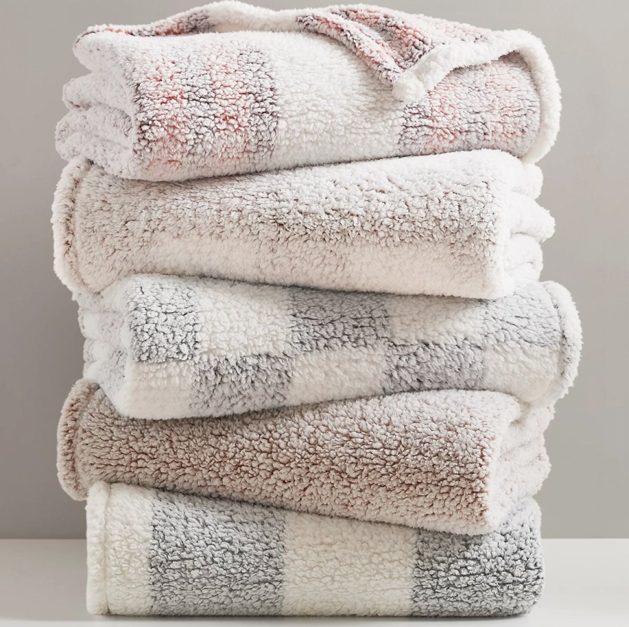 stack of folded sherpa throw blankets