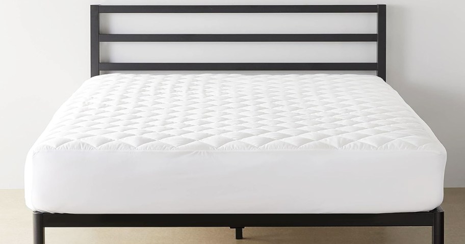 white quilted mattress protector on a bed