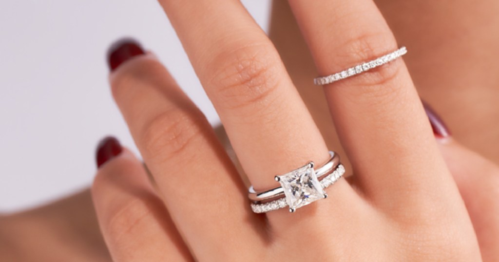 woman wearing silver wedding rings on 2 different fingers