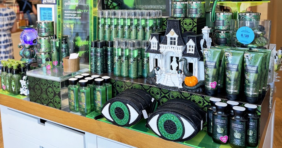 store display of green bath & body works halloween products