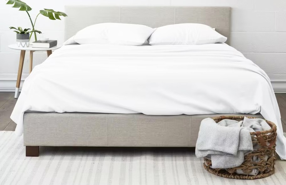 white sheets and pillows on a bed