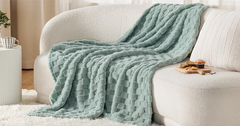 Bedsure Sage Green Fleece Blanket draped over sofa