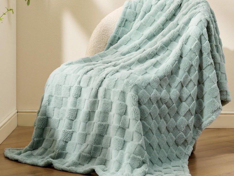 Bedsure Sage Green Fleece Blanket draped over accent chair