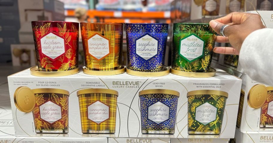 A hand holding Bellevue Luxury Candle 4-Pack