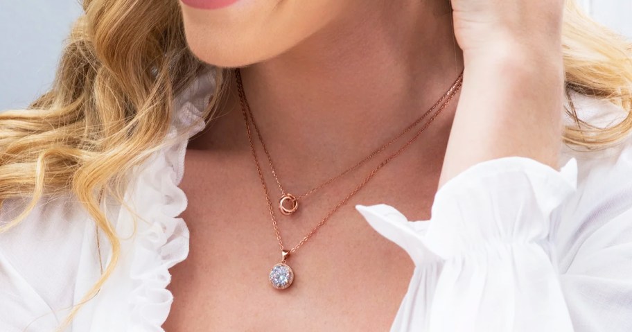 woman wearing two rose gold necklaces