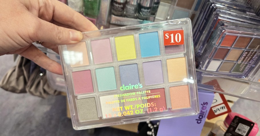 hand holding up a colorful eyeshadow palette