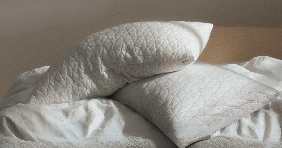 2 white memory foam pillows on a bed