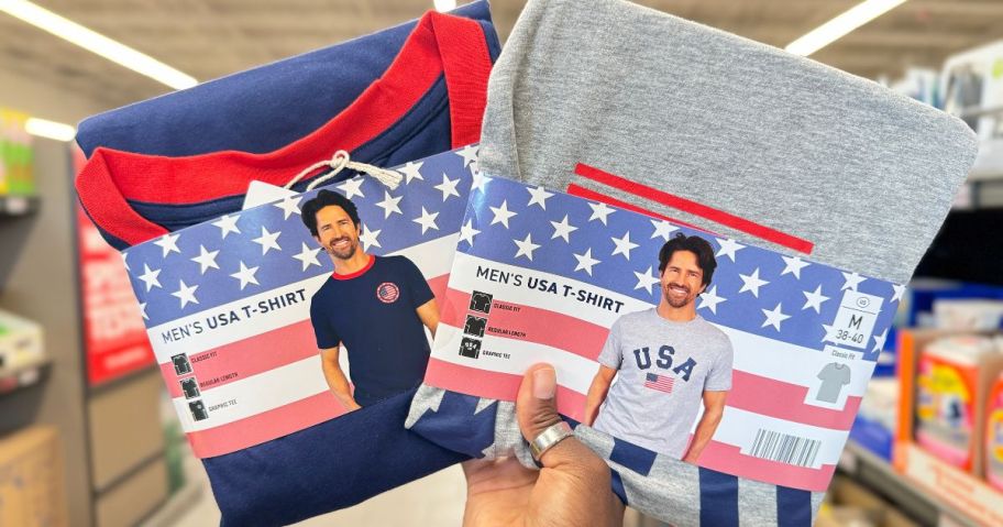 A person holding 2 USA t-shirts