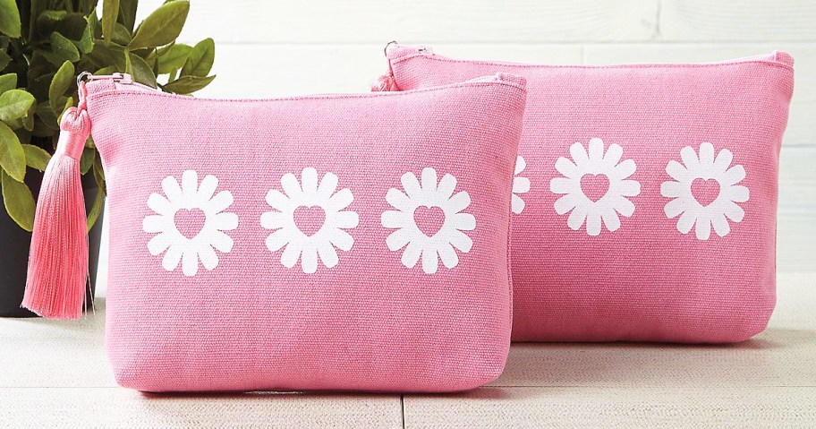 two pink makeup bags with daisy print