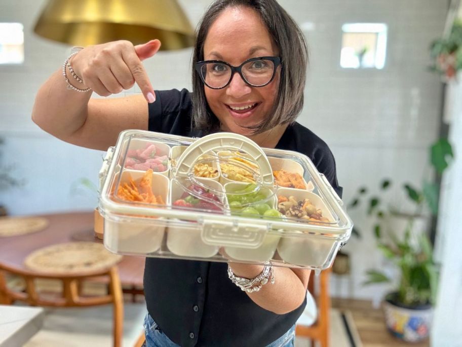 A woman holding a Divided Serving Tray with lid and Handle