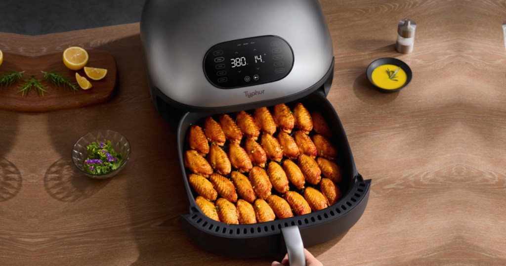 silver air fryer filled with 23 chicken wings