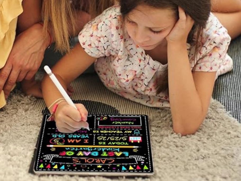 girl writing on Double-Sided First Day & Last of School Chalkboard Board