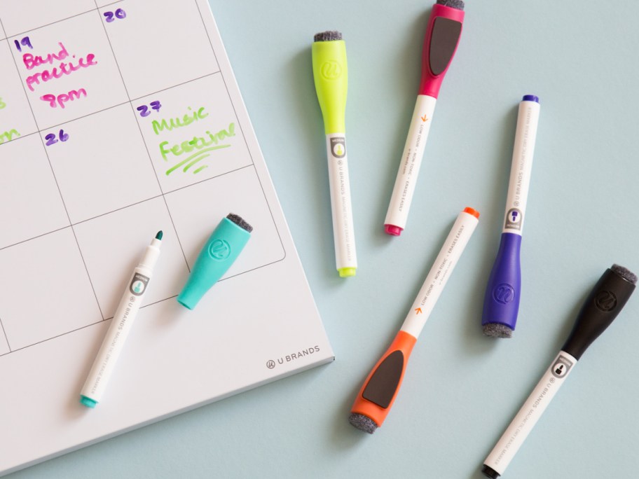 Dry erase markers with dry erase board next to it