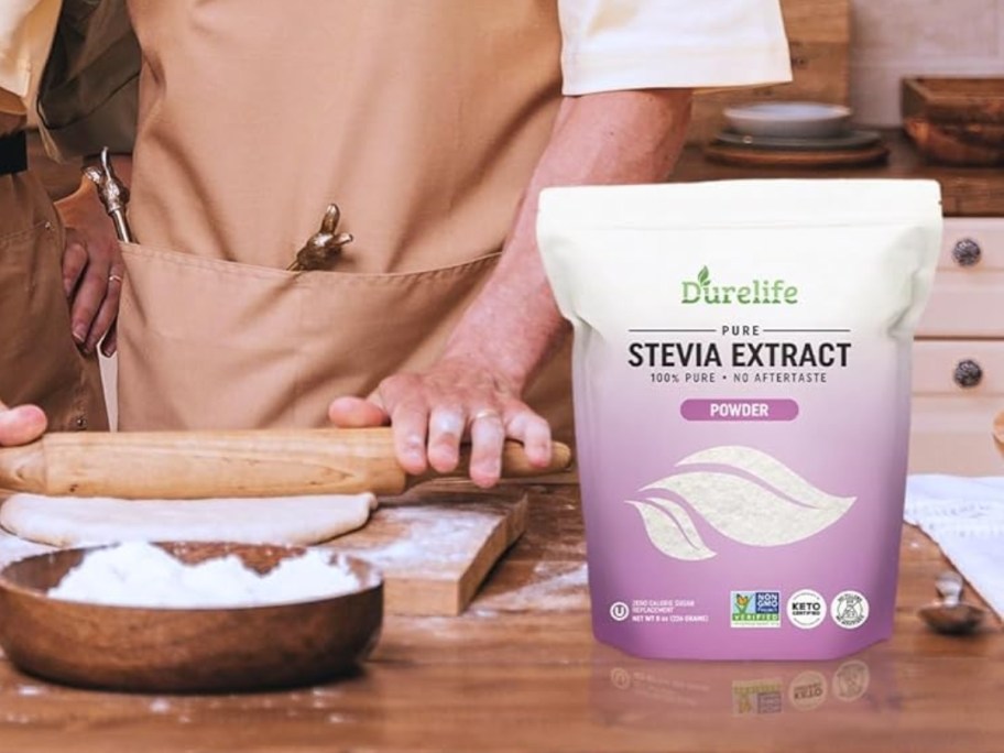 person rolling out pie dough with a rolling pin, bag of Durelife 100% Pure Stevia Extract to the side